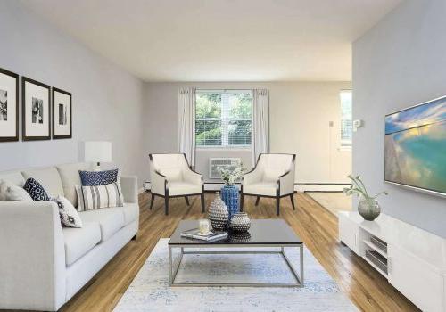 Living room with a couch, chair, and TV at Eola Park apartments for rent in Philadelphia, PA